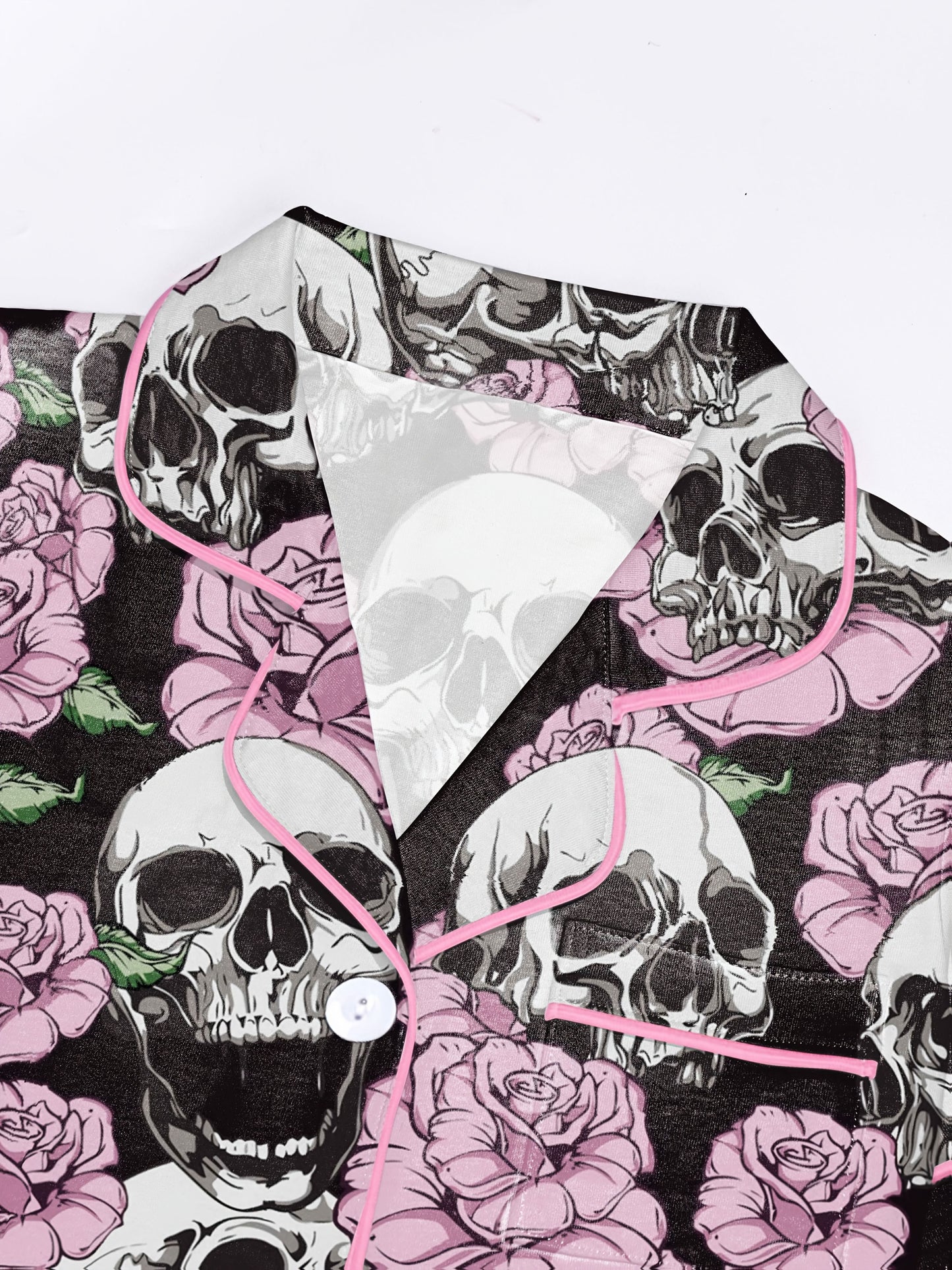 Black modal pajama set with white skulls and pink roses — short‑sleeve button top and elastic waist shorts with pale contrast piping