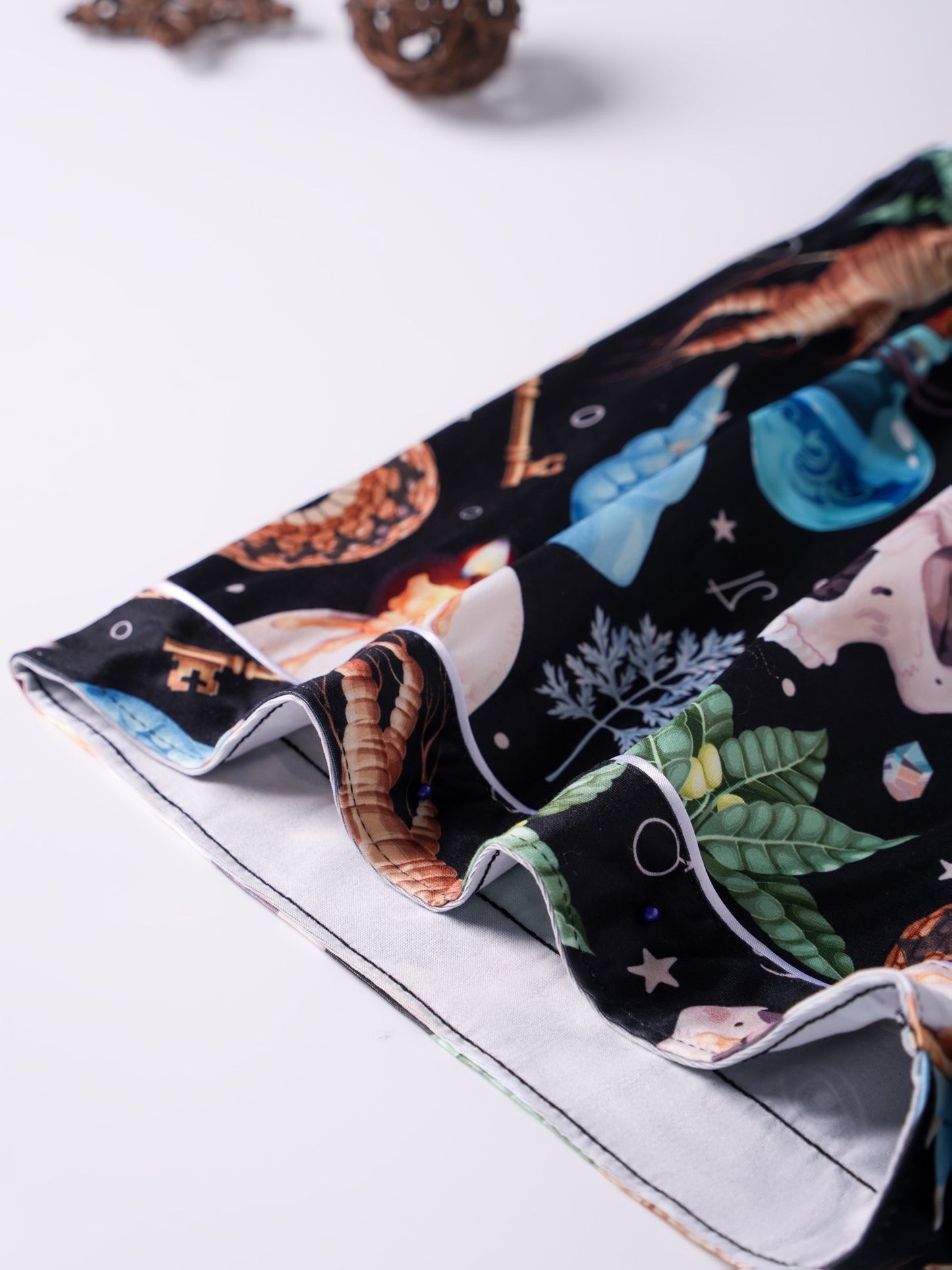 Black modal pajama set with skulls, snake and crystal print — short‑sleeve button top and elastic waist shorts with pale piping