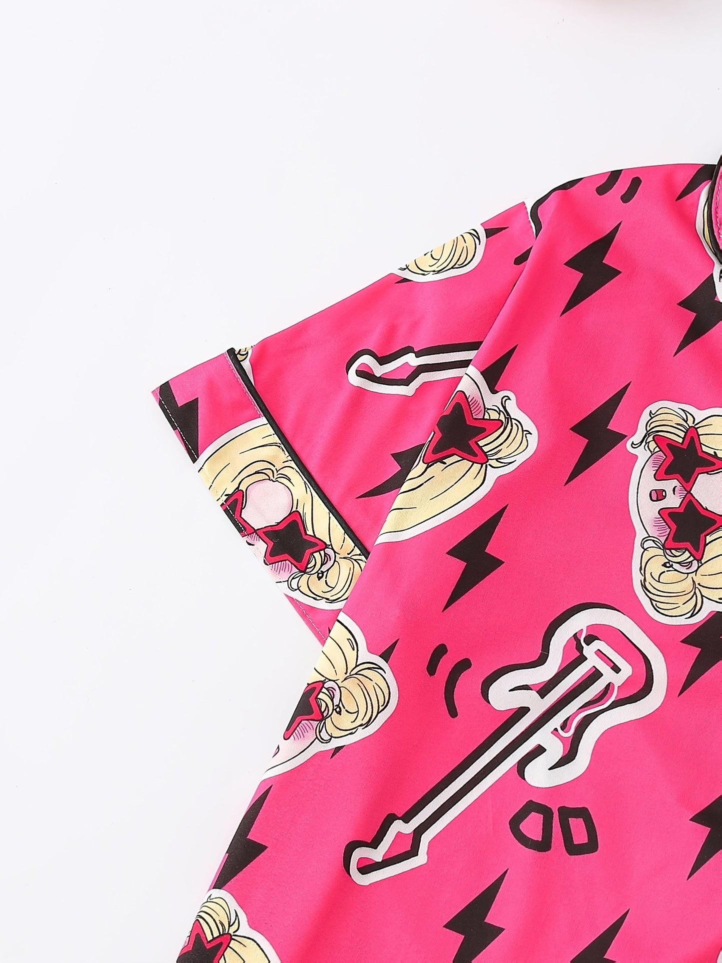 Bright pop-pink satin-look short-sleeve pajama set with guitar and star-sunglasses print, piped trim, chest pocket and elastic waist shorts in 95% Polyester 5% Elastane — silky stretch travel-ready loungewear