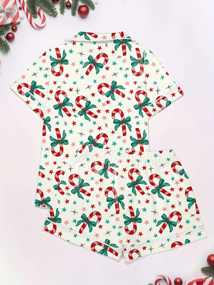 Cream cotton pajama set with candy‑cane and green bow print — short‑sleeve button top and elastic waist shorts with piping