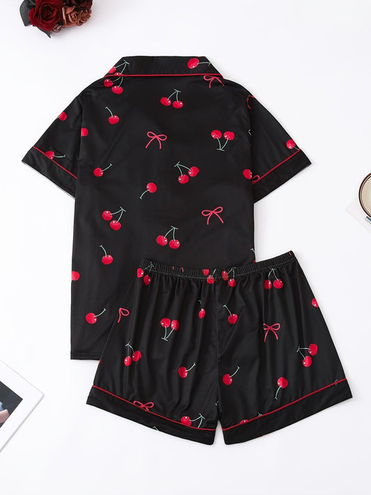 Black satin-look short-sleeve pajama set with red cherry print, piped trim, chest pocket and elastic waist shorts in 95% Polyester 5% Elastane