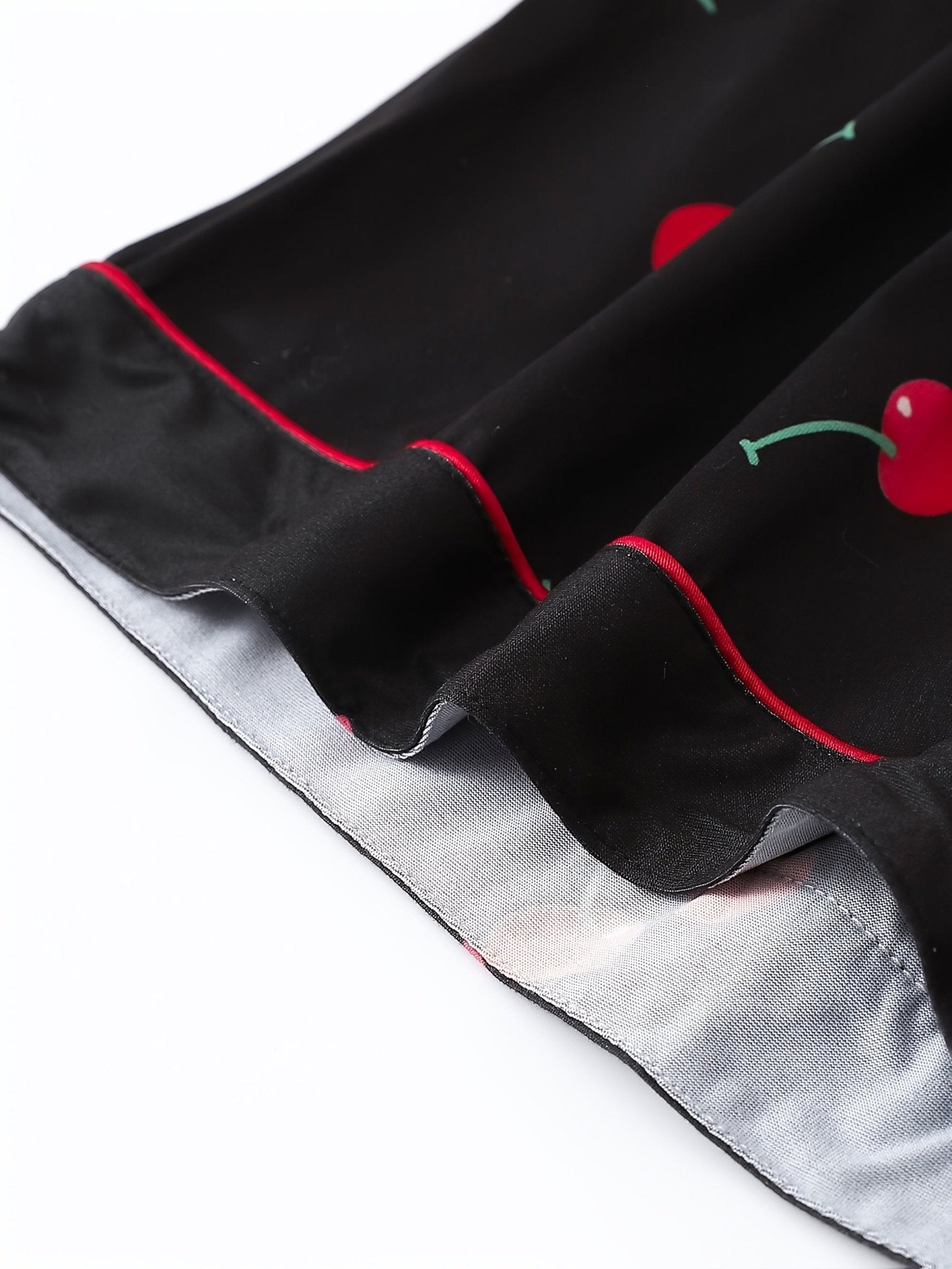 Black satin-look short-sleeve pajama set with red cherry print, piped trim, chest pocket and elastic waist shorts in 95% Polyester 5% Elastane