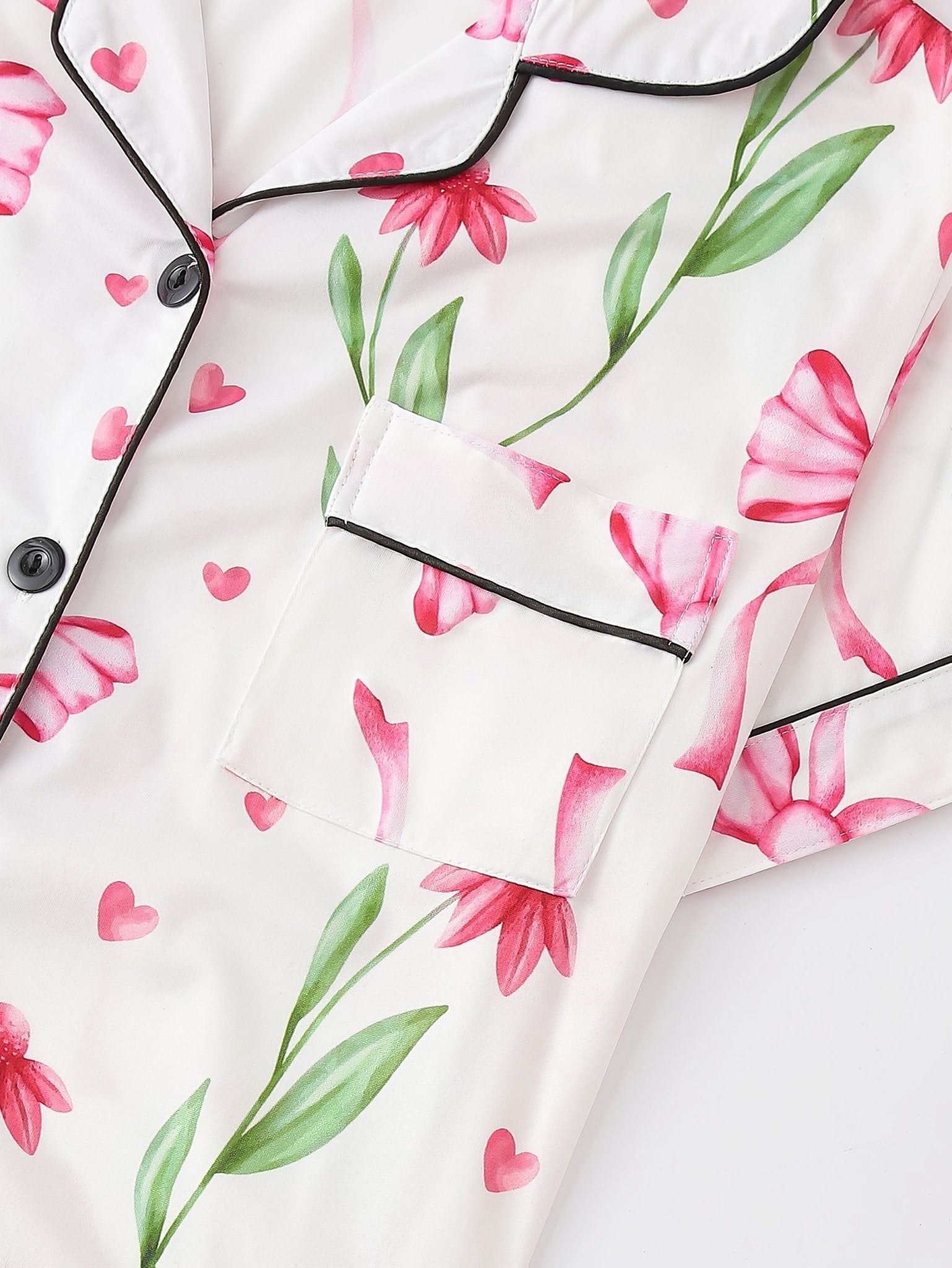 White satin-look short-sleeve pajama set with pink bow and floral print, piped trim, chest pocket and elastic waist shorts in 95% Polyester 5% Elastane — travel-ready silky stretch loungewear