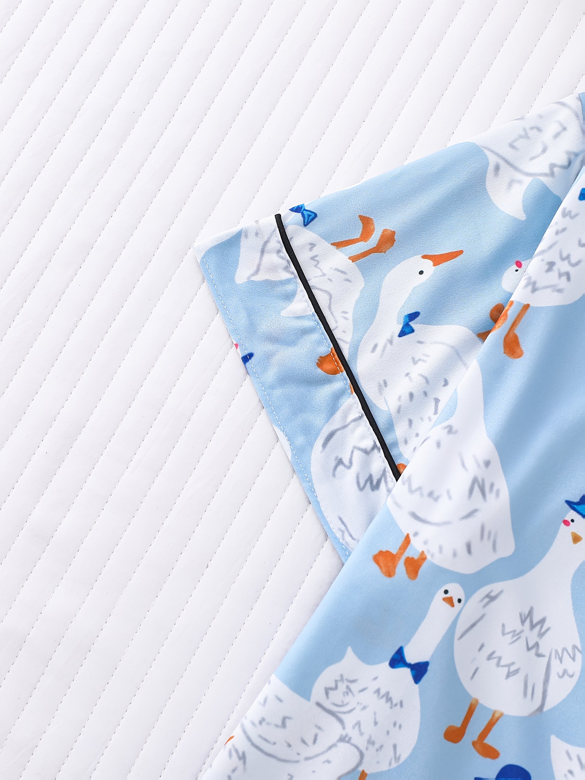 Light blue goose print satin-look pajama set with piped trim, short sleeve button top and elastic waist shorts in silky stretch fabric — 95% Polyester/5% Elastane