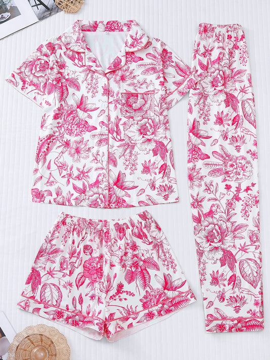 White satin-look pajama set with pink toile floral print — short-sleeve button-up top with chest pocket, elastic waist shorts and full-length pants, 95% Polyester/5% Elastane