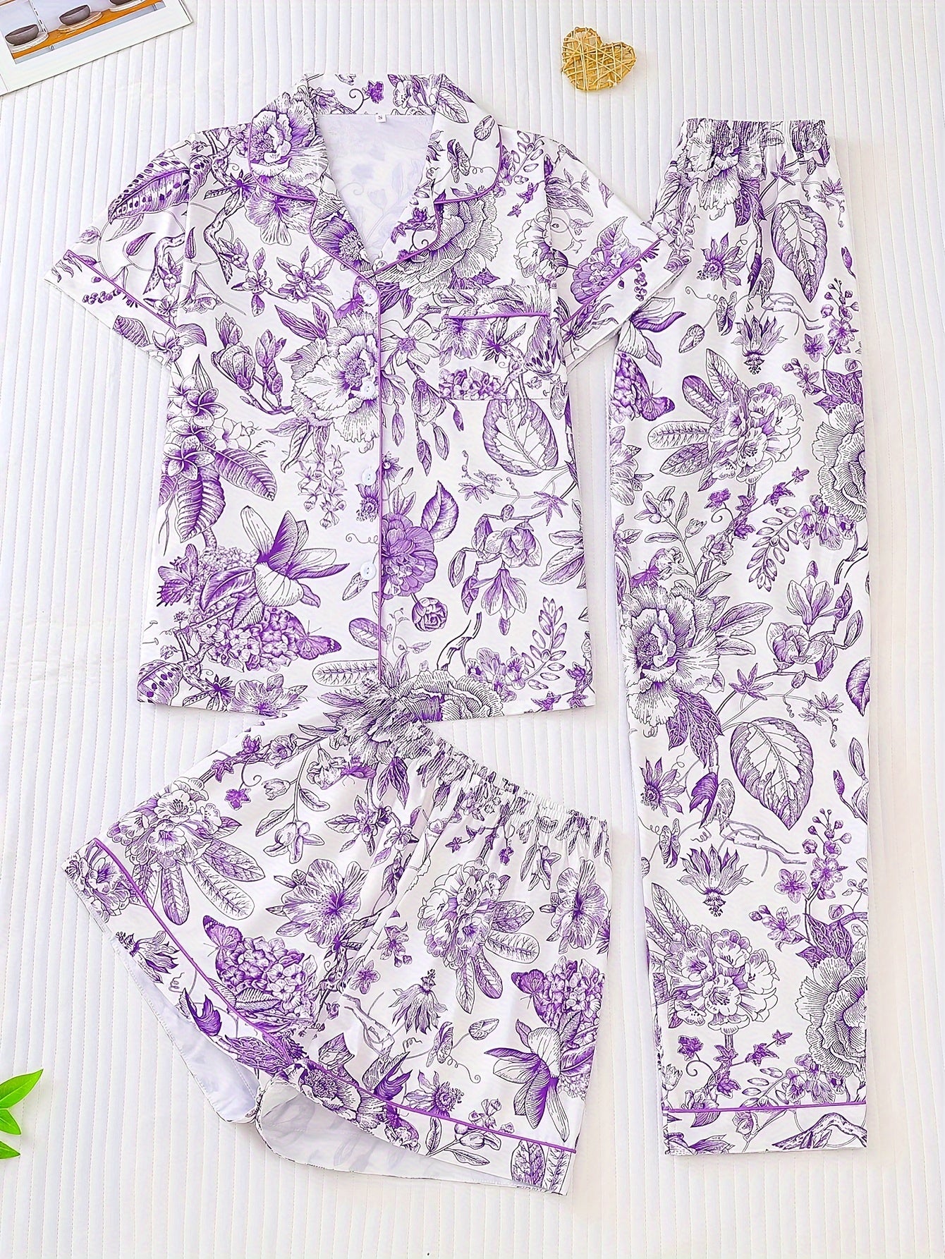 White satin-look pajama set with pink toile floral print — short-sleeve button-up top with chest pocket, elastic waist shorts and full-length pants, 95% Polyester/5% Elastane