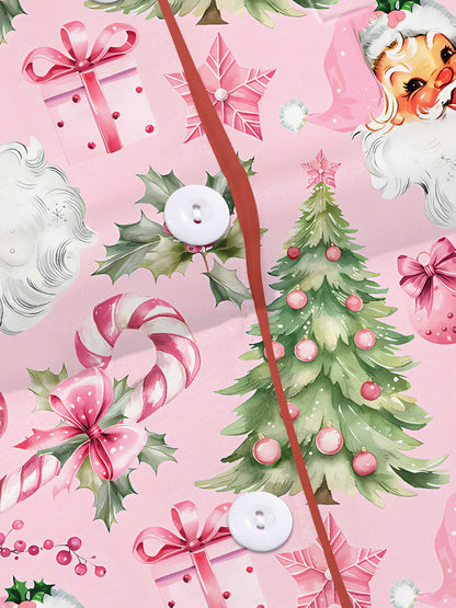 Pastel pink short-sleeve pajama set with vintage Santa faces, decorated Christmas trees and candy cane print — button-up top and elastic waist shorts with contrast piping