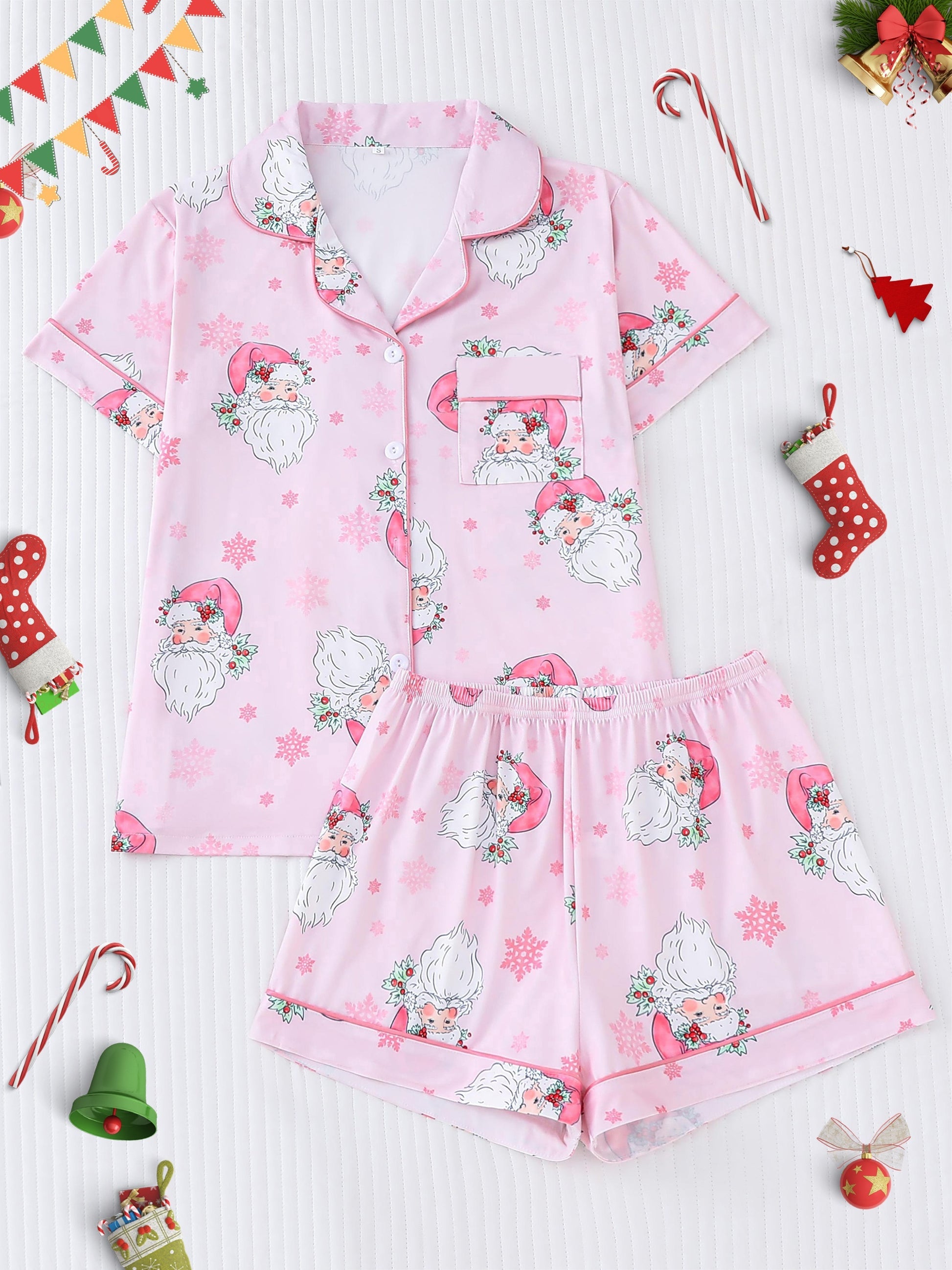 Pale pink satin-look pajama set with vintage Santa faces and snowflake print — short-sleeve button-up top with chest pocket and elastic waist shorts, 95% Polyester/5% Elastane
