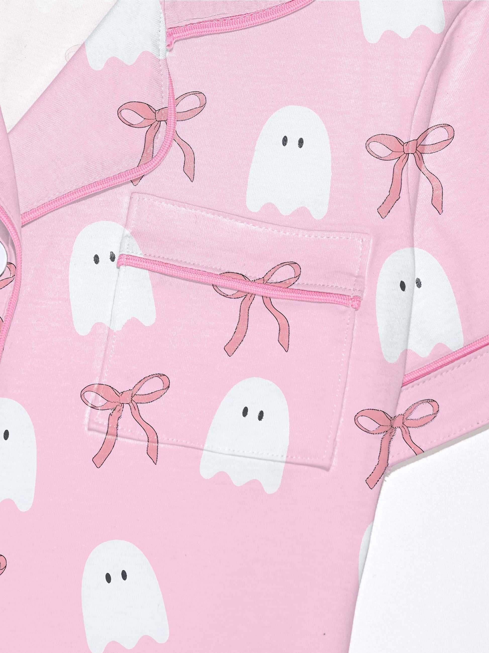 Pink cotton pajama set with white ghost and ribbon print — short sleeve notch collar top and elastic waist shorts