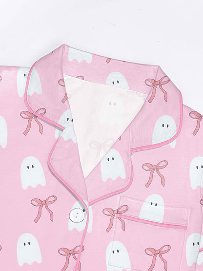 Pink cotton pajama set with white ghost and ribbon print — short sleeve notch collar top and elastic waist shorts