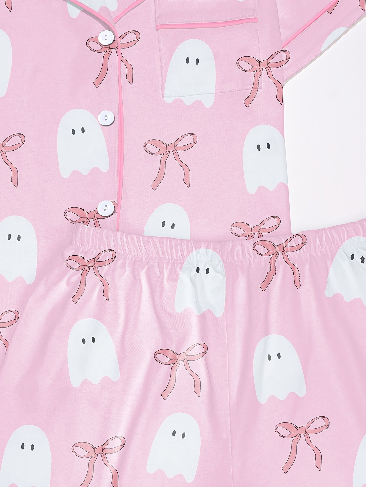 Pink cotton pajama set with white ghost and ribbon print — short sleeve notch collar top and elastic waist shorts