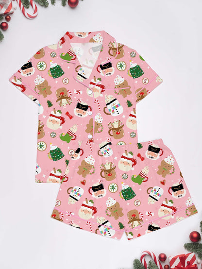 Pink satin‑look sleep shorts with playful Christmas icons — Santa mugs, snowmen, gingerbread, reindeer and candy — elastic waist and white piping