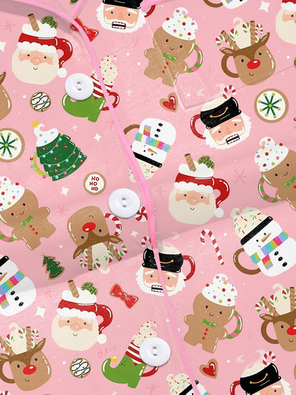 Pink satin‑look sleep shorts with playful Christmas icons — Santa mugs, snowmen, gingerbread, reindeer and candy — elastic waist and white piping