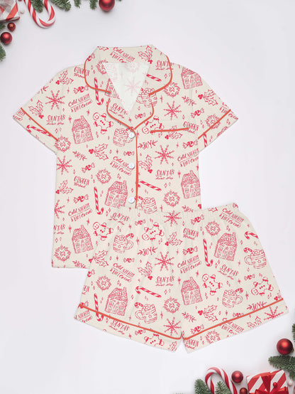 Cream short-sleeve women’s pajama set with red holiday sketch print of gingerbread houses, candy canes and cocoa mugs — short top and elastic waist shorts in 95% polyester 5% elastane
