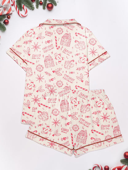 Cream short-sleeve women’s pajama set with red holiday sketch print of gingerbread houses, candy canes and cocoa mugs — short top and elastic waist shorts in 95% polyester 5% elastane