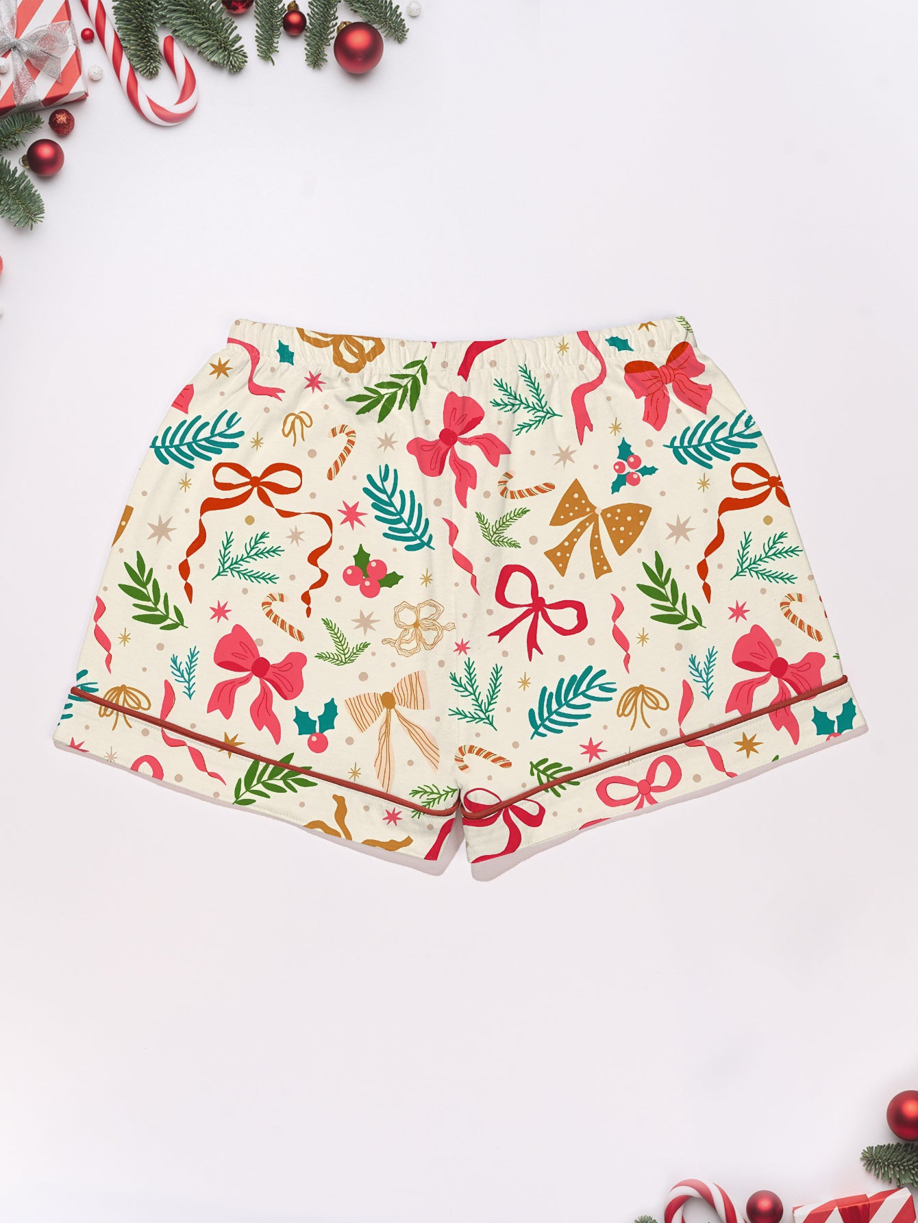Cream cotton short-sleeve pajama set with pink and gold ribbon and greenery print — button-up top and elastic waist shorts with contrast piping