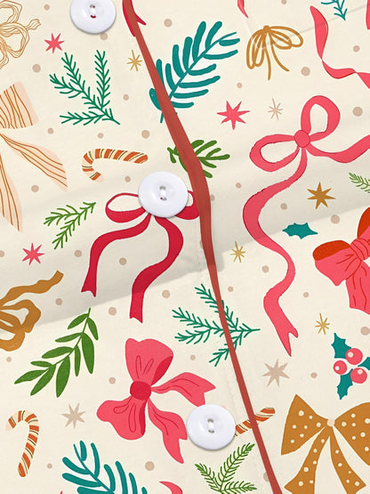 Cream cotton short-sleeve pajama set with pink and gold ribbon and greenery print — button-up top and elastic waist shorts with contrast piping