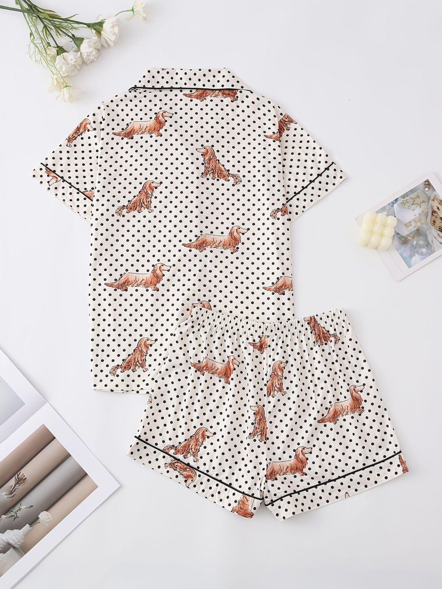 Cream and black polka dot satin-look pajama set with dachshund print, piped trim, chest pocket and elastic waist shorts in 95% Polyester 5% Elastane — silky stretch travel-ready loungewear