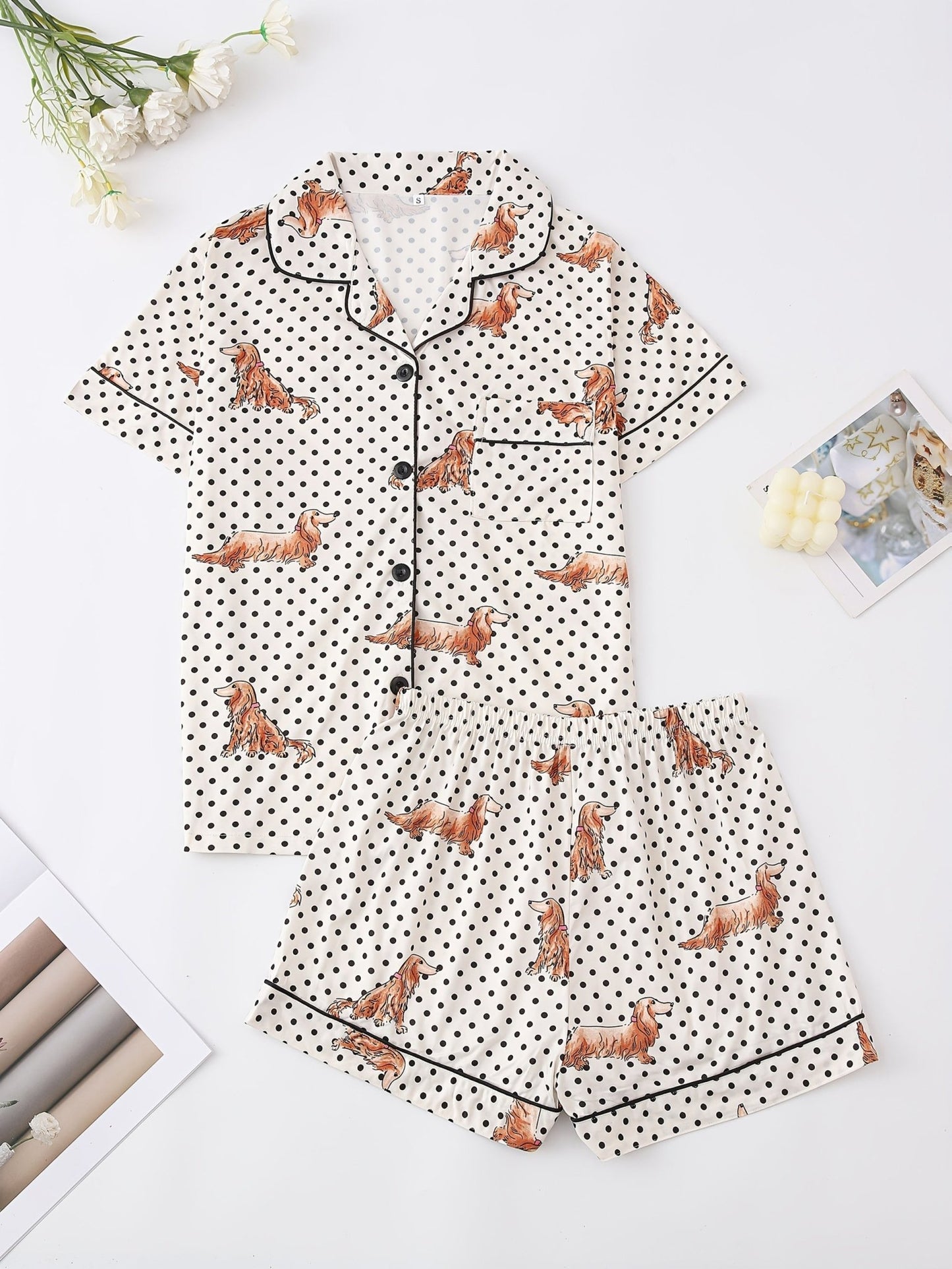 Cream and black polka dot satin-look pajama set with dachshund print, piped trim, chest pocket and elastic waist shorts in 95% Polyester 5% Elastane — silky stretch travel-ready loungewear