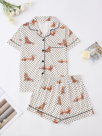 Cream and black polka dot satin-look pajama set with dachshund print, piped trim, chest pocket and elastic waist shorts in 95% Polyester 5% Elastane — silky stretch travel-ready loungewear