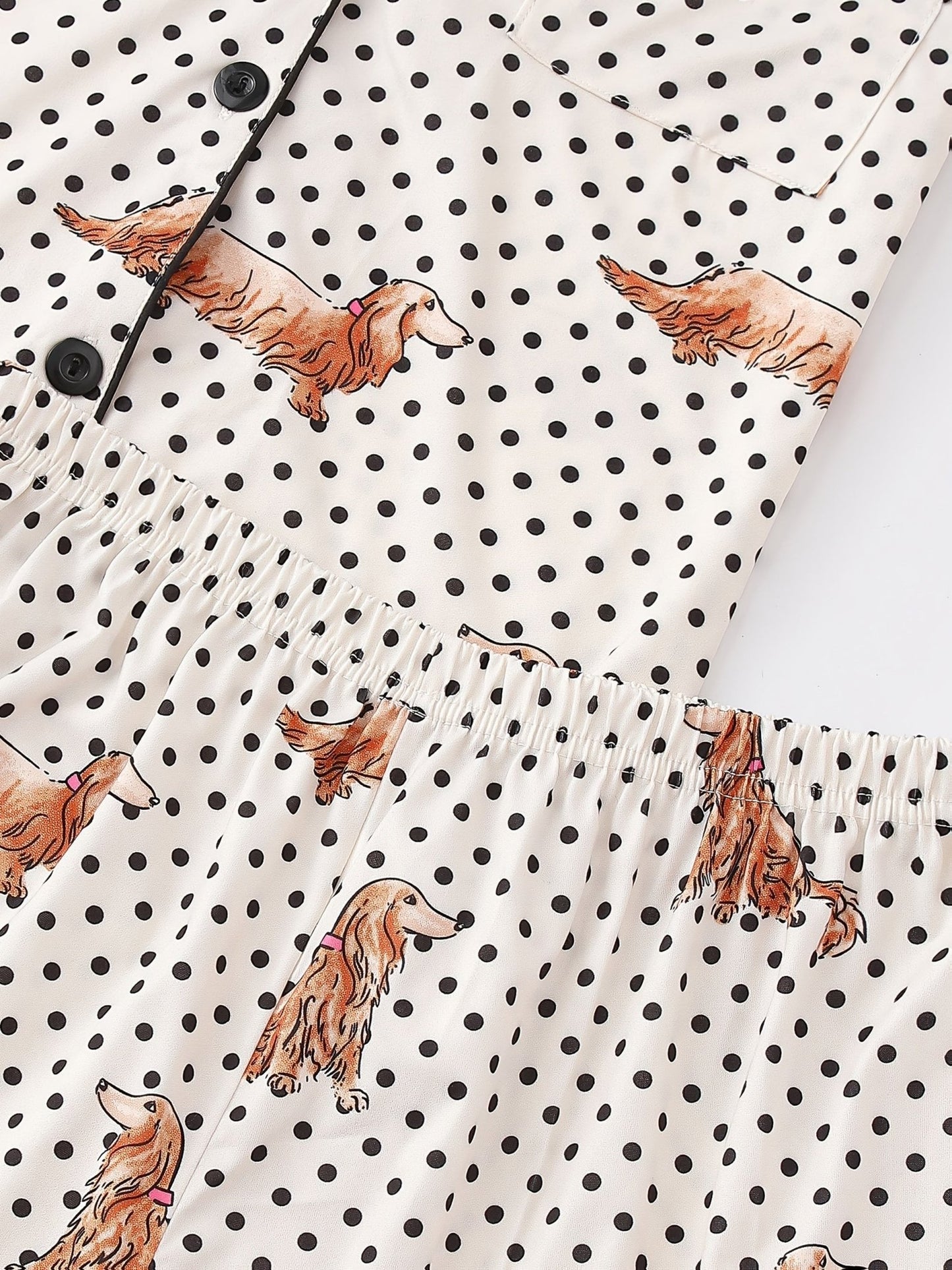 Cream and black polka dot satin-look pajama set with dachshund print, piped trim, chest pocket and elastic waist shorts in 95% Polyester 5% Elastane — silky stretch travel-ready loungewear