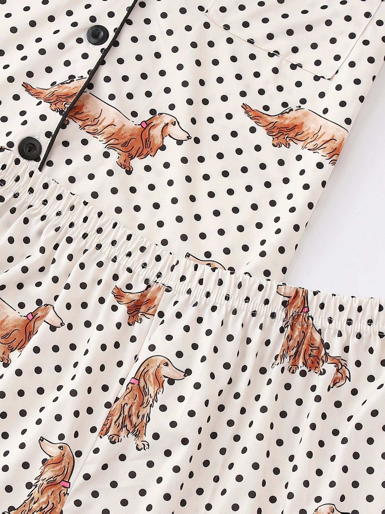 Cream and black polka dot satin-look pajama set with dachshund print, piped trim, chest pocket and elastic waist shorts in 95% Polyester 5% Elastane — silky stretch travel-ready loungewear