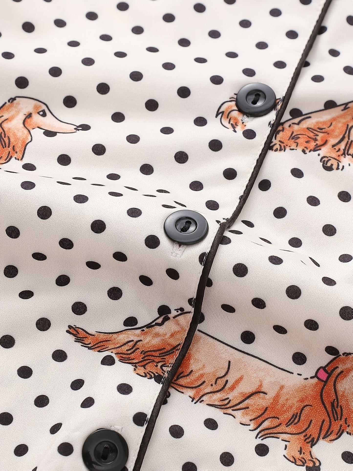 Cream and black polka dot satin-look pajama set with dachshund print, piped trim, chest pocket and elastic waist shorts in 95% Polyester 5% Elastane — silky stretch travel-ready loungewear