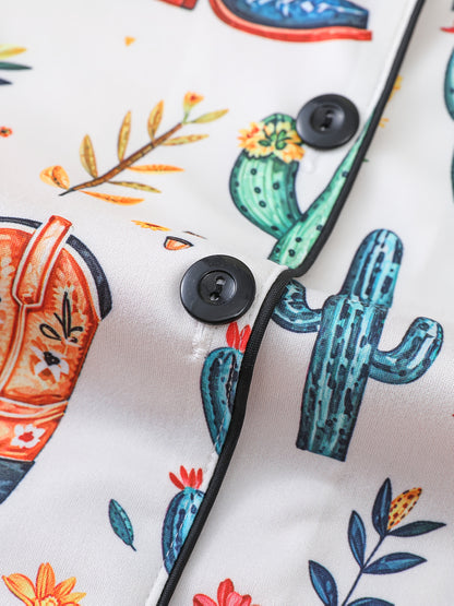 Ivory satin-look pajama set with watercolor cactus and floral print — close-up of glossy black buttons, contrast piping and smooth fabric (95% Polyester/5% Elastane)