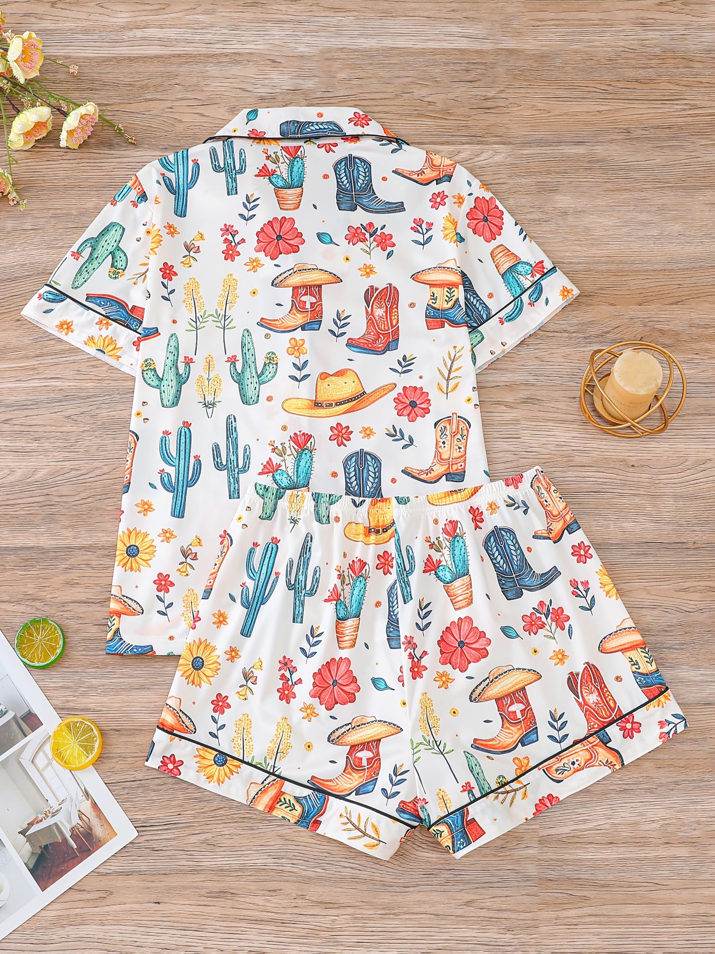 Ivory satin-look pajama set with watercolor cactus and floral print — close-up of glossy black buttons, contrast piping and smooth fabric (95% Polyester/5% Elastane)