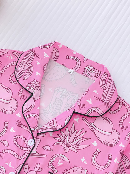 Bubblegum pink satin-look short pajama set with cowboy boots, hats and cactus print — button-up short-sleeve top with chest pocket and elastic waist shorts, 95% Polyester/5% Elastane