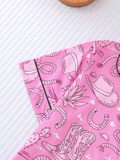 Bubblegum pink satin-look short pajama set with cowboy boots, hats and cactus print — button-up short-sleeve top with chest pocket and elastic waist shorts, 95% Polyester/5% Elastane