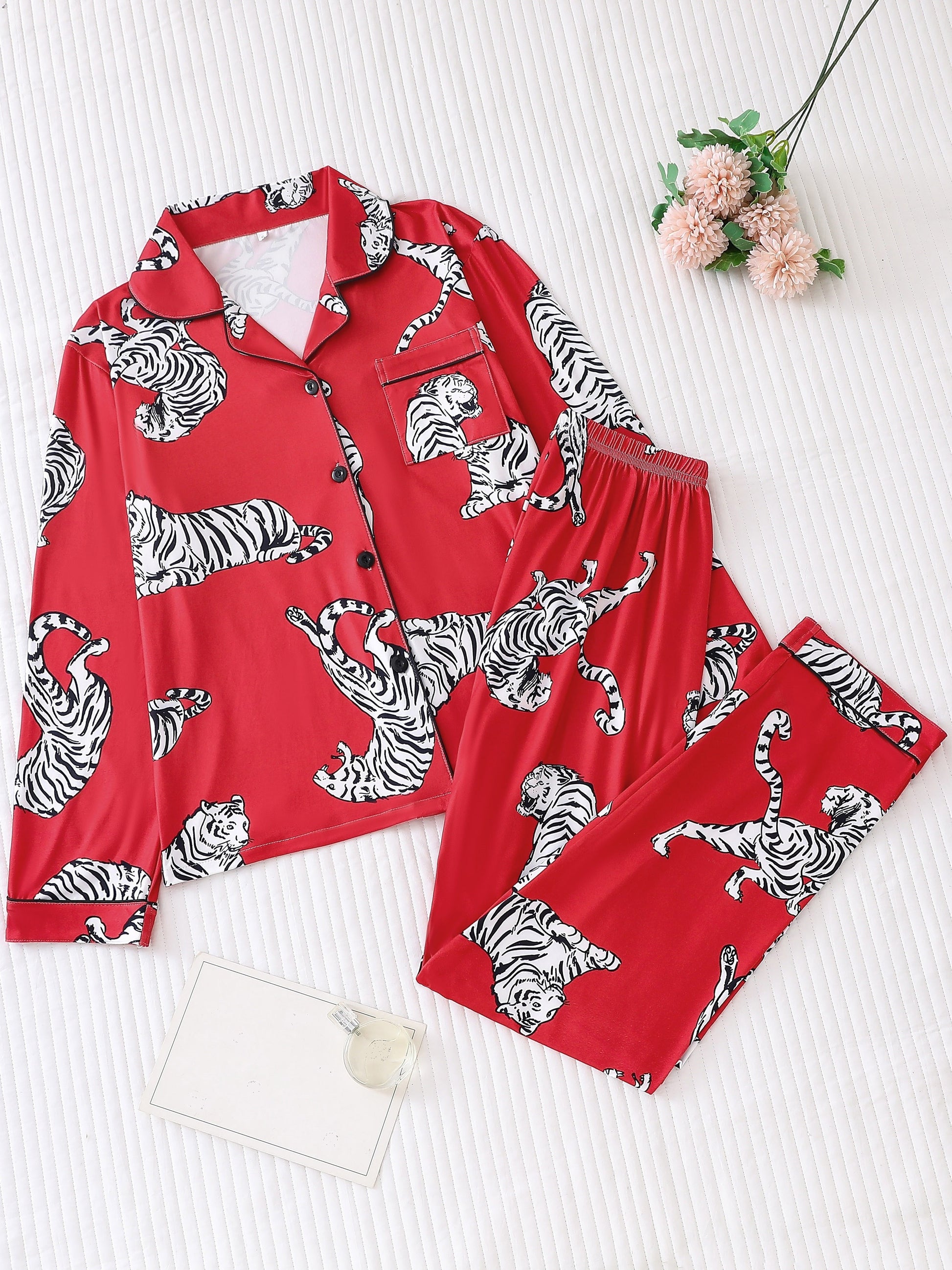 Fuchsia satin-look pajama set with white-and-black tiger print — long-sleeve button-up top with chest pocket and elastic waist pants, 95% Polyester/5% Elastane