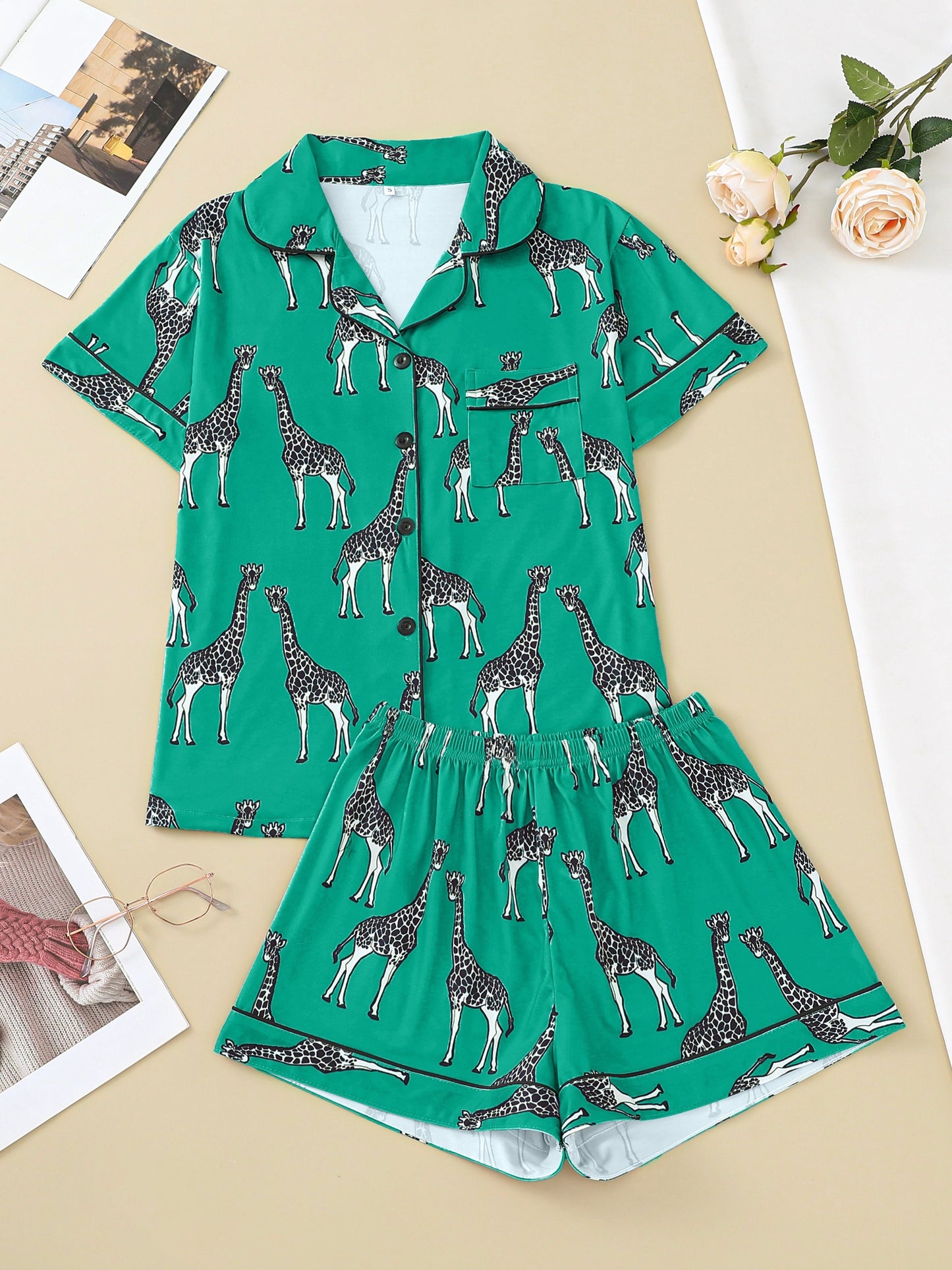 Hot satin-look pajama set with black-and-white giraffe print — short-sleeve button-up top with chest pocket and elastic waist shorts, 95% Polyester/5% Elastane