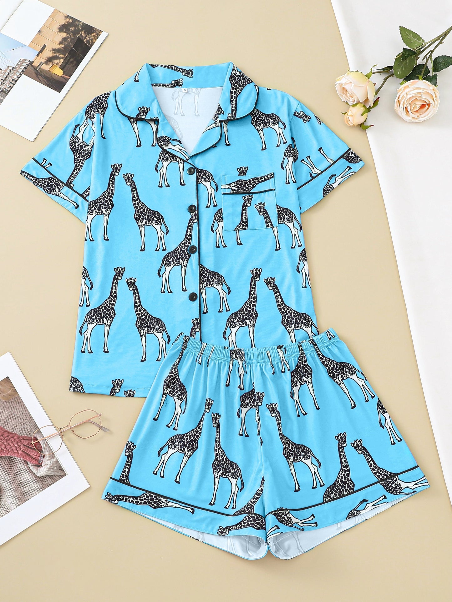 Hot satin-look pajama set with black-and-white giraffe print — short-sleeve button-up top with chest pocket and elastic waist shorts, 95% Polyester/5% Elastane