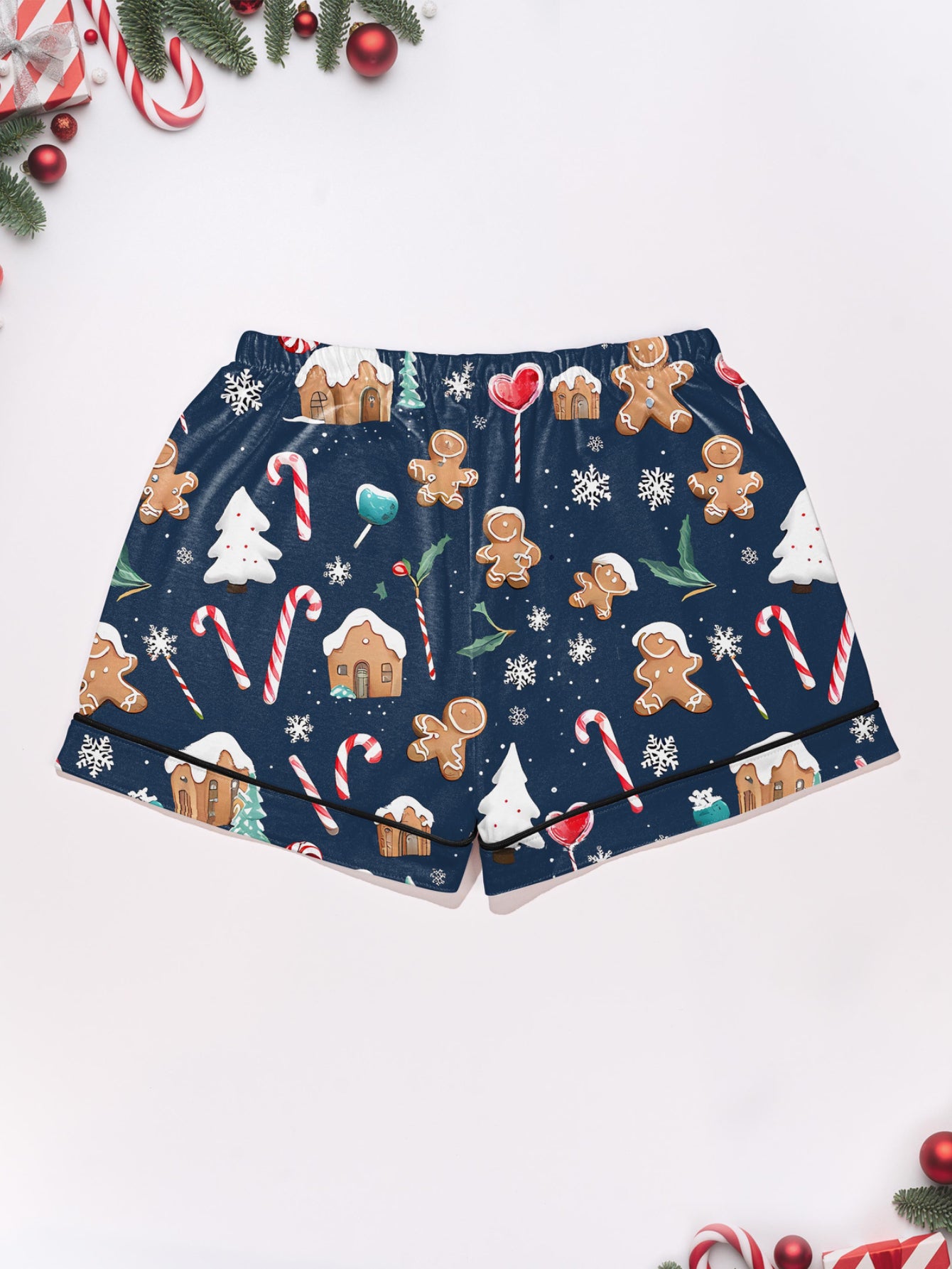 Navy modal pajama set with gingerbread men, candy canes and cottages print — short‑sleeve button top and elastic waist shorts with piping