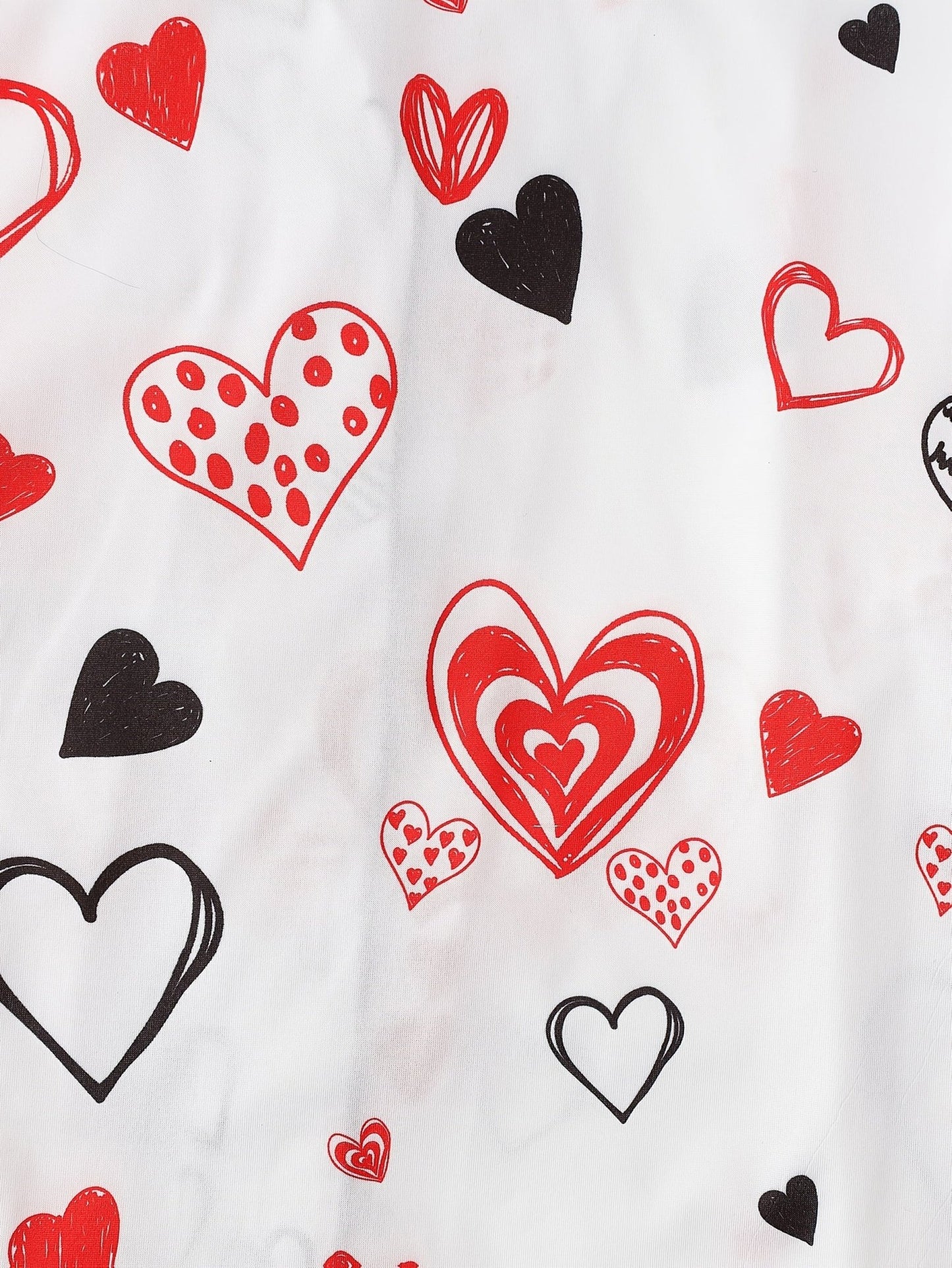 White satin-look short-sleeve pajama set with red and black hand-drawn heart print, piped trim, chest pocket and elastic waist shorts in 95% Polyester 5% Elastane — silky stretch travel-ready loungewear