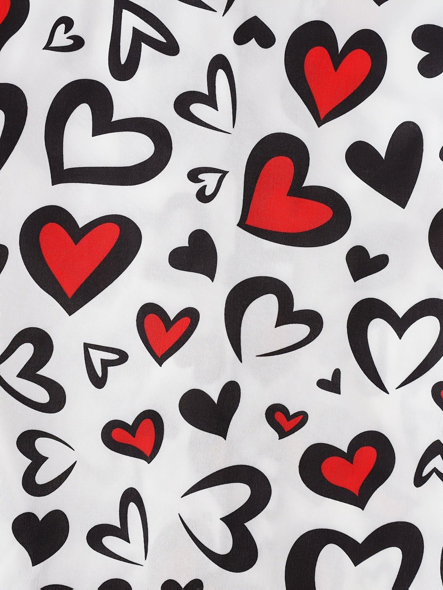 White satin-look short-sleeve pajama set with red and black heart print, piped trim, chest pocket and elastic waist shorts in 95% Polyester 5% Elastane — silky stretch travel-ready loungewear