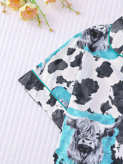 Cream satin-look short pajama set with highland cow portrait and cowhide splatter print — short-sleeve relaxed top and elastic waist shorts, 95% Polyester/5% Elastane, lightweight and breathable