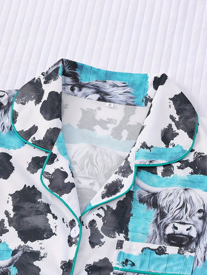 Cream satin-look short pajama set with highland cow portrait and cowhide splatter print — short-sleeve relaxed top and elastic waist shorts, 95% Polyester/5% Elastane, lightweight and breathable