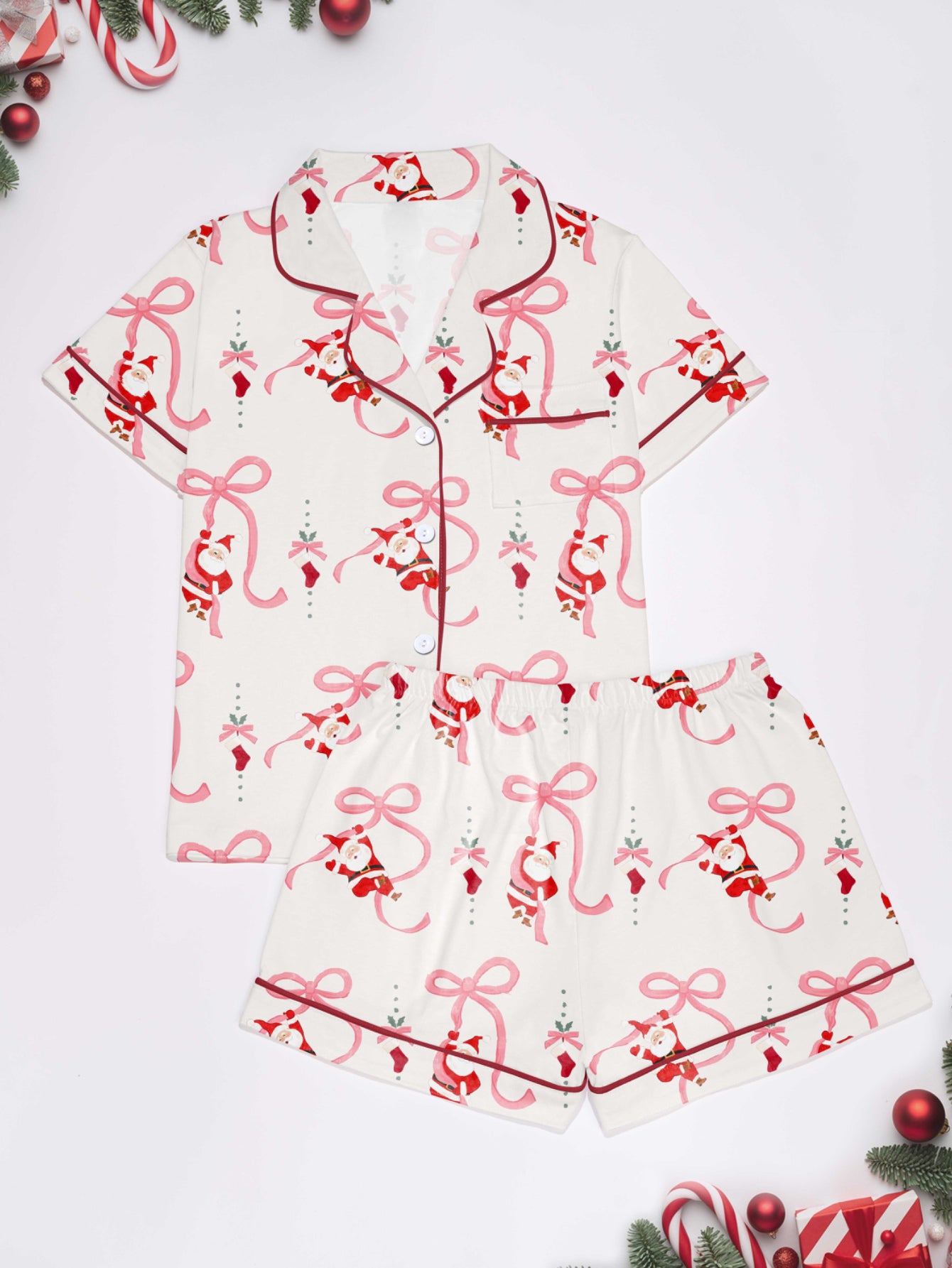 Cream modal pajama set with Santa and pink ribbon print — short‑sleeve button top and elastic waist shorts with pink piping