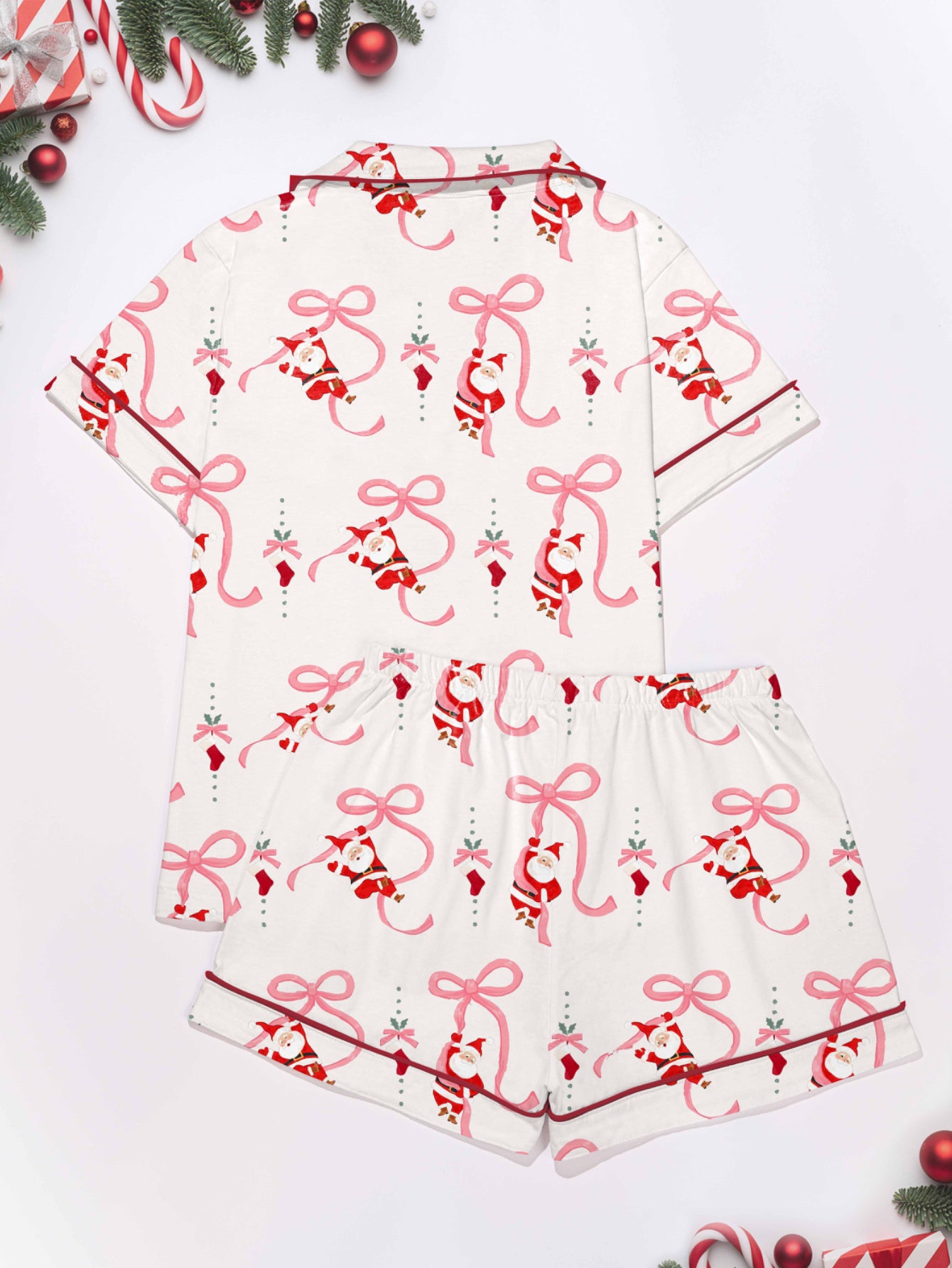 Cream modal pajama set with Santa and pink ribbon print — short‑sleeve button top and elastic waist shorts with pink piping