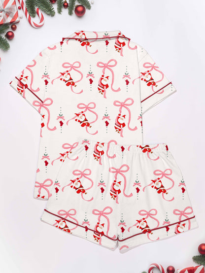 Cream modal pajama set with Santa and pink ribbon print — short‑sleeve button top and elastic waist shorts with pink piping