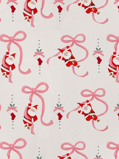 Cream modal pajama set with Santa and pink ribbon print — short‑sleeve button top and elastic waist shorts with pink piping
