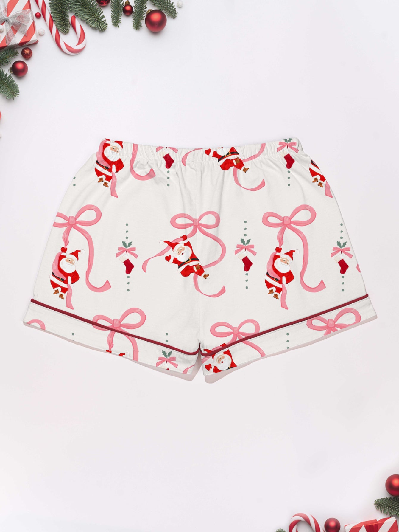 Cream modal pajama set with Santa and pink ribbon print — short‑sleeve button top and elastic waist shorts with pink piping 