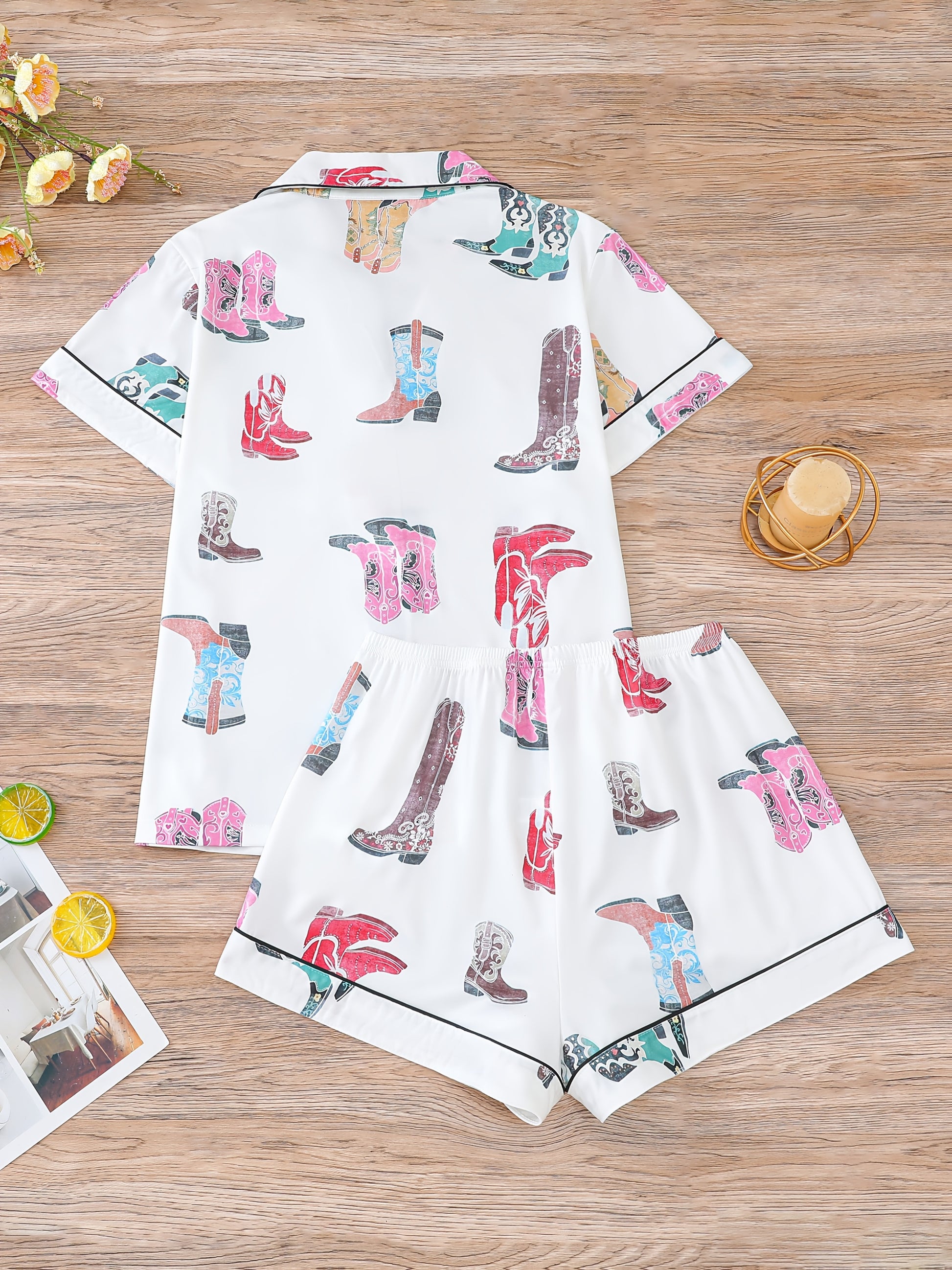 Ivory satin-look pajama set with colorful cowboy-boot print — short-sleeve button-up top with chest pocket and elastic waist shorts, 95% Polyester/5% Elastane