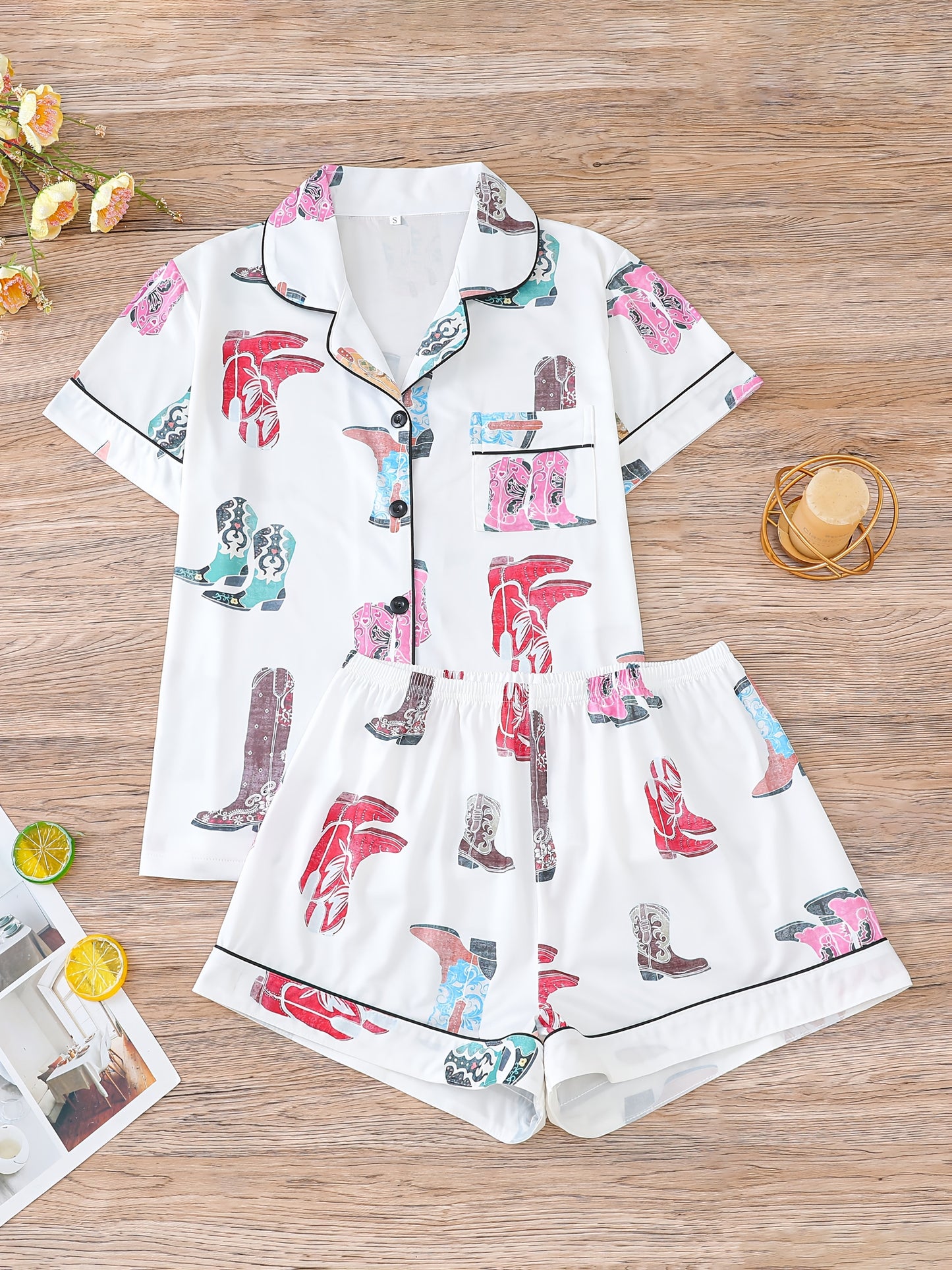 Ivory satin-look pajama set with colorful cowboy-boot print — short-sleeve button-up top with chest pocket and elastic waist shorts, 95% Polyester/5% Elastane