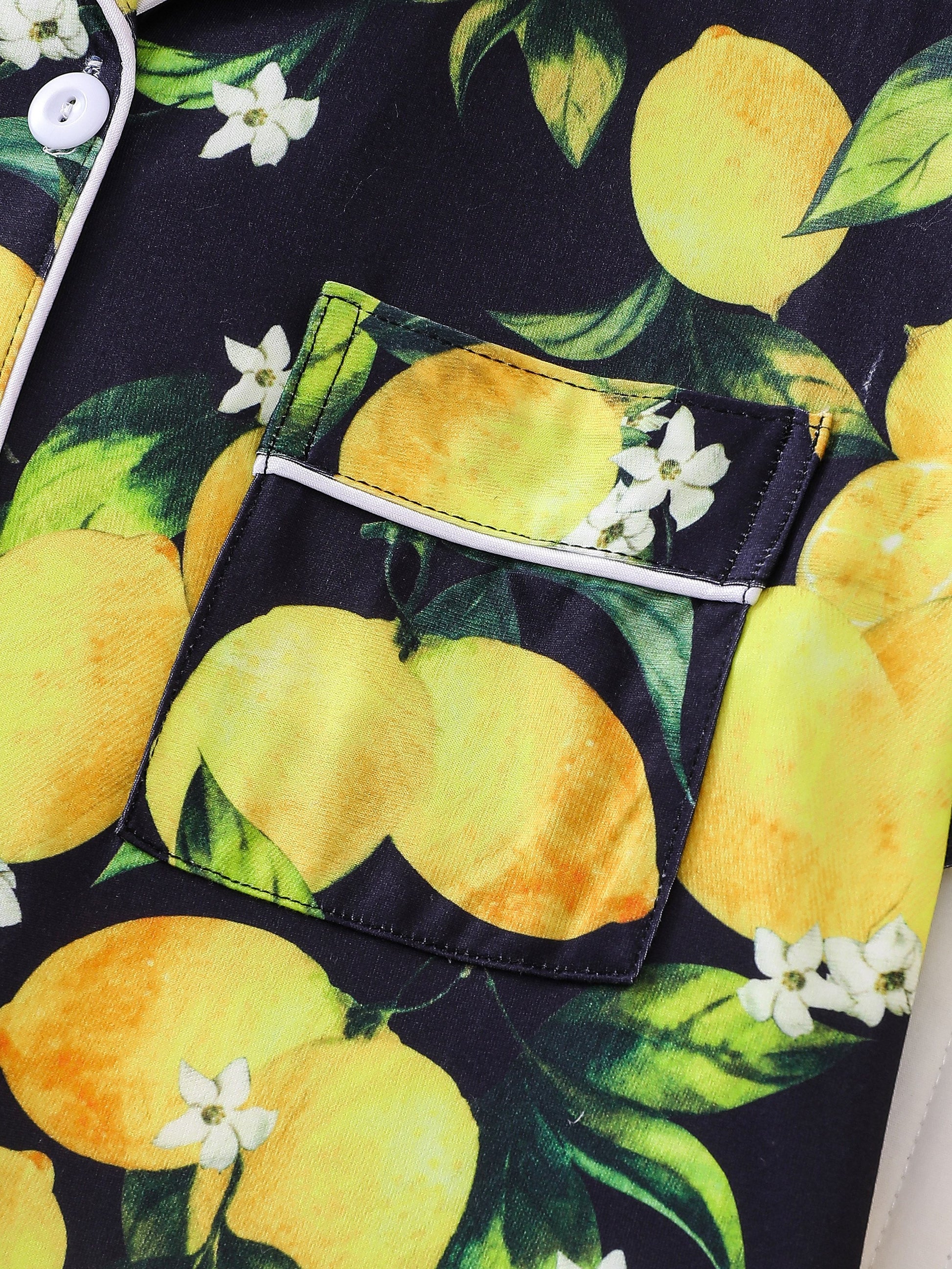 Navy satin-look short pajama set with bright watercolor lemon and green leaf print — short-sleeve relaxed top and elastic waist shorts, 95% Polyester/5% Elastane, lightweight and breathable