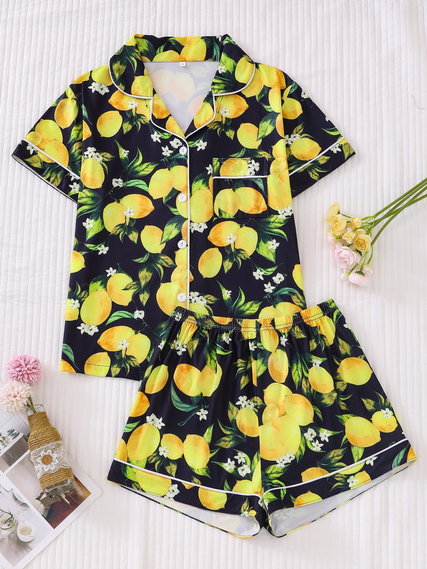 Navy satin-look short pajama set with bright watercolor lemon and green leaf print — short-sleeve relaxed top and elastic waist shorts, 95% Polyester/5% Elastane, lightweight and breathable
