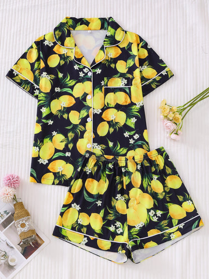 Navy satin-look short pajama set with bright watercolor lemon and green leaf print — short-sleeve relaxed top and elastic waist shorts, 95% Polyester/5% Elastane, lightweight and breathable