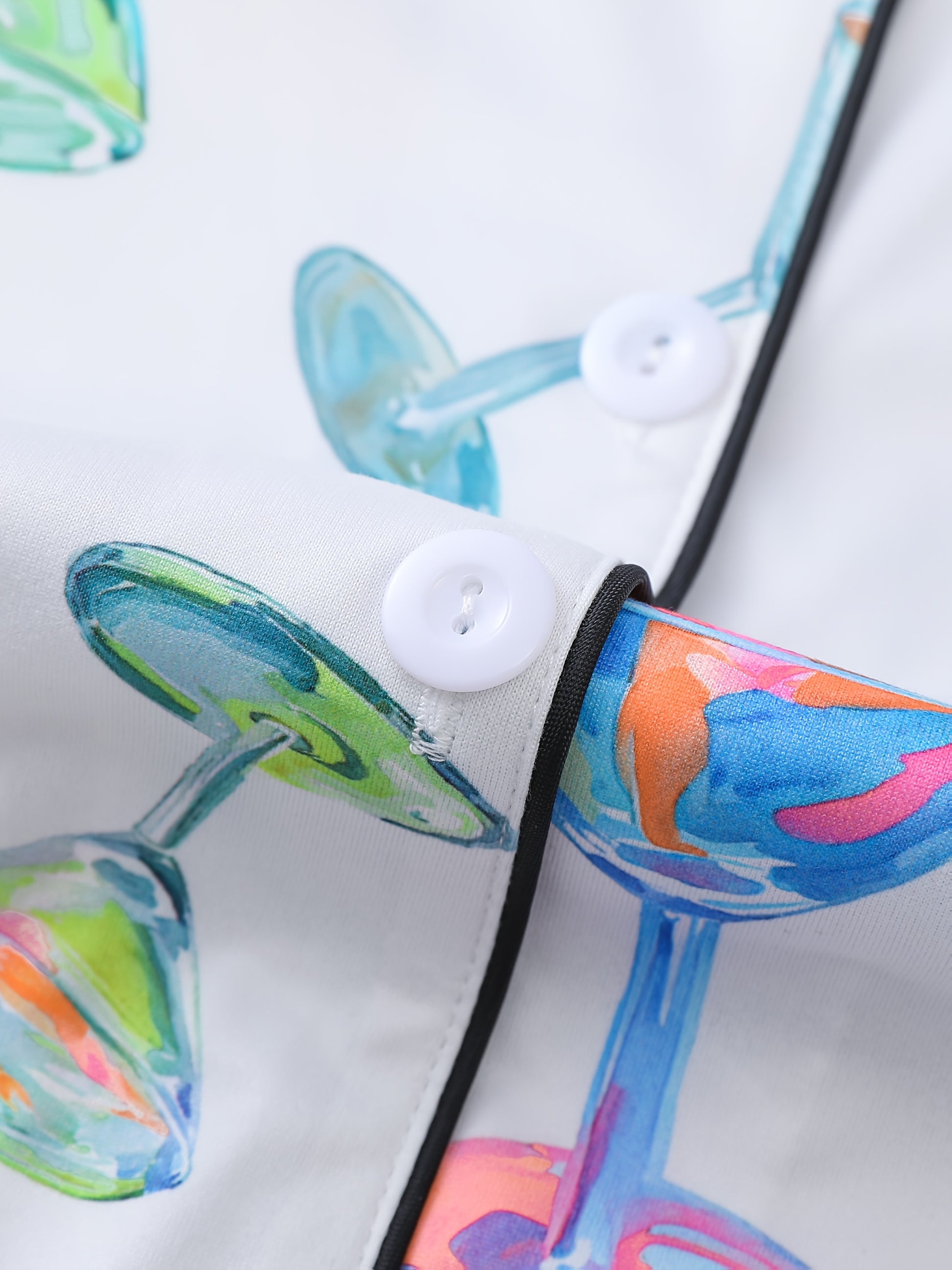 White satin-look pajama set with watercolor martini glass print, short-sleeve button top with piped pocket and elastic waist shorts — 95% Polyester/5% Elastane, silky and breathable